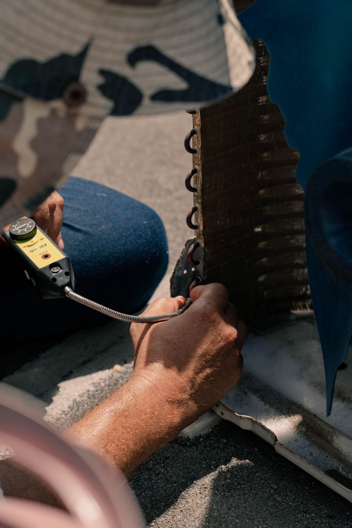 Technician installing an air conditioning unit with tools